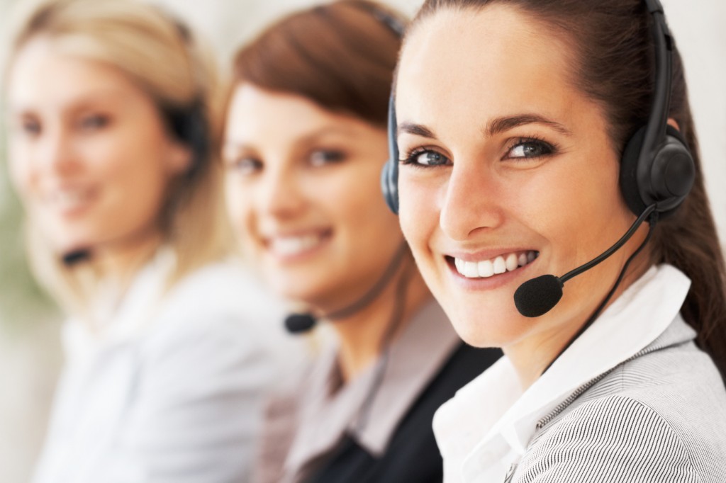 Closeup of customer service representative with colleagues in background